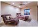 Spacious bedroom showcases plush carpeting, ceiling fan, bed, chaise, and outdoor view at 31721 N 138Th Pl, Scottsdale, AZ 85262