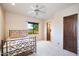 Bright bedroom with a metal bed frame, view of the outdoors and neutral tones at 31721 N 138Th Pl, Scottsdale, AZ 85262