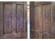 Rustic wooden doors leading into a house at 31721 N 138Th Pl, Scottsdale, AZ 85262