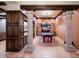 Elegant game room featuring coffered ceilings, stone columns, a stylish chandelier, and a pool table with backyard access at 31721 N 138Th Pl, Scottsdale, AZ 85262