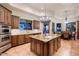 Spacious kitchen with a granite island, wooden cabinets, stainless steel appliances, and a view of the backyard at 31721 N 138Th Pl, Scottsdale, AZ 85262