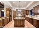 Gourmet kitchen featuring custom wood cabinets, granite countertops, stainless steel appliances, and a center island at 31721 N 138Th Pl, Scottsdale, AZ 85262