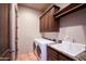 Well-lit laundry room features a washing machine, dryer, sink, and lots of cabinet space at 31721 N 138Th Pl, Scottsdale, AZ 85262
