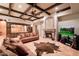 Cozy living room featuring tile flooring, ceiling fans, a fireplace, coffered ceilings, and comfortable seating at 31721 N 138Th Pl, Scottsdale, AZ 85262