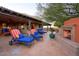 Serene outdoor patio featuring a fireplace, lounge chairs, and lush green landscape at 31721 N 138Th Pl, Scottsdale, AZ 85262