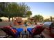 Outdoor patio space with lounge chairs, an outdoor fireplace, and a built-in grill, perfect for entertaining at 31721 N 138Th Pl, Scottsdale, AZ 85262