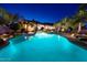 Captivating backyard pool with palm trees and resort-style lounging areas at twilight at 31721 N 138Th Pl, Scottsdale, AZ 85262