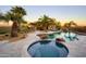 Resort-style pool and spa area featuring a waterfall, lush landscaping, and comfortable lounge chairs at 31721 N 138Th Pl, Scottsdale, AZ 85262