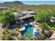 Aerial view of a sparkling pool, lush landscaping, and comfortable lounge chairs creating an inviting outdoor oasis at 31721 N 138Th Pl, Scottsdale, AZ 85262