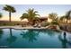 Lush backyard pool area with lounge chairs and rock waterfall at 31721 N 138Th Pl, Scottsdale, AZ 85262
