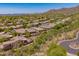 Aerial view of homes in a desert community with mature trees and beautiful desert landscaping at 41227 N Rolling Green Way, Anthem, AZ 85086
