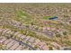 Aerial view of an upscale desert community featuring a lush green golf course and lake at 41227 N Rolling Green Way, Anthem, AZ 85086