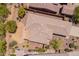 Aerial shot of home with a desert-landscaped backyard, covered patio, and surrounding wrought iron fence at 41227 N Rolling Green Way, Anthem, AZ 85086