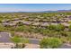 Expansive aerial view of desert homes with desert landscaping in a well-planned community at 41227 N Rolling Green Way, Anthem, AZ 85086