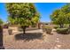 Backyard featuring desert landscaping and covered patio at 41227 N Rolling Green Way, Anthem, AZ 85086