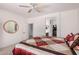Comfortable bedroom with ceiling fan and view to the ensuite bathroom and walk in closet at 41227 N Rolling Green Way, Anthem, AZ 85086