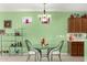 Bright dining area featuring a glass table and decorative shelving with natural light at 41227 N Rolling Green Way, Anthem, AZ 85086