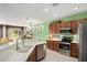 Open kitchen with stainless appliances, bar seating, and easy access to the living area at 41227 N Rolling Green Way, Anthem, AZ 85086