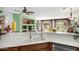 Bright and airy kitchen featuring a bar, modern appliances and seamless access to the living room at 41227 N Rolling Green Way, Anthem, AZ 85086