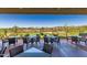 Outdoor patio seating with golf course views, desert landscape and beautiful blue sky at 41227 N Rolling Green Way, Anthem, AZ 85086