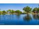 Scenic view of pond in community park with fountains and shaded seating areas at 41227 N Rolling Green Way, Anthem, AZ 85086