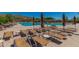 Relaxing pool area with lounge chairs and umbrellas, perfect for enjoying the sunny weather at 41227 N Rolling Green Way, Anthem, AZ 85086