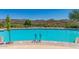 Inviting community pool with a scenic mountain view backdrop, perfect for relaxation and recreation at 41227 N Rolling Green Way, Anthem, AZ 85086