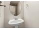 Elegant bathroom featuring a pedestal sink, stylish faucet, and an oval mirror at 41251 W Cahill Dr, Maricopa, AZ 85138