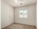 Bedroom featuring neutral carpeting, a ceiling fan, and bright window at 41251 W Cahill Dr, Maricopa, AZ 85138