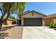Charming single-Gathering home with a two car garage, desert landscaping, and a beautiful shade tree at 41251 W Cahill Dr, Maricopa, AZ 85138