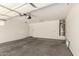 Spacious two car garage with ample room for parking and storage, featuring a water heater at 41251 W Cahill Dr, Maricopa, AZ 85138