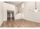 Bright living room featuring high ceilings, light wood flooring, and a staircase leading to the second floor at 41251 W Cahill Dr, Maricopa, AZ 85138