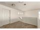 Second floor loft area featuring neutral carpet, and a view to the stairs and second floor hallway at 41251 W Cahill Dr, Maricopa, AZ 85138
