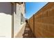 Narrow side yard with stone pavers, gravel, and a block wall providing extra privacy at 41251 W Cahill Dr, Maricopa, AZ 85138