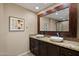 Elegant bathroom featuring dual sinks, granite countertops, and a glass-enclosed shower at 4200 N Miller Rd # 408, Scottsdale, AZ 85251