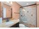 Bathroom with stone countertops, framed mirror and glass door shower at 4200 N Miller Rd # 408, Scottsdale, AZ 85251