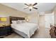 Comfortable bedroom with ceiling fan, neutral colors, and plush bedding at 4200 N Miller Rd # 408, Scottsdale, AZ 85251
