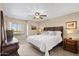 Bright bedroom with a ceiling fan, natural light, and a comfortable bed at 4200 N Miller Rd # 408, Scottsdale, AZ 85251