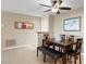 Traditional dining room features neutral walls, tiled floors, ceiling fan and a modern dining table set with bench at 4200 N Miller Rd # 408, Scottsdale, AZ 85251