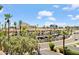 View of complex with lush trees, red tiled roofs and palm trees at 4200 N Miller Rd # 408, Scottsdale, AZ 85251