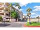 Beautiful condo building with lush landscaping and palm trees in a well-maintained community at 4200 N Miller Rd # 408, Scottsdale, AZ 85251