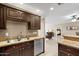 Well-equipped kitchen with modern appliances, granite countertops, and wooden cabinets at 4200 N Miller Rd # 408, Scottsdale, AZ 85251