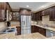 Well-appointed kitchen features a large stainless steel refrigerator, modern appliances, and granite countertops at 4200 N Miller Rd # 408, Scottsdale, AZ 85251