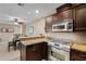 Open kitchen concept with granite countertops, stainless appliances and seamless access to the dining area at 4200 N Miller Rd # 408, Scottsdale, AZ 85251