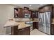 Cozy kitchen features stainless steel appliances, granite countertops, and wooden cabinets at 4200 N Miller Rd # 408, Scottsdale, AZ 85251