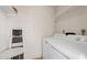 Bright laundry room with white washer, dryer and shelving at 4200 N Miller Rd # 408, Scottsdale, AZ 85251