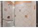 Shower with glass door, patterned tile walls, and a rainfall shower head at 4200 N Miller Rd # 408, Scottsdale, AZ 85251