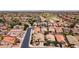 Aerial view of a street showcasing single-story homes, desert landscaping and well maintained streets at 42076 W Colby Dr, Maricopa, AZ 85138