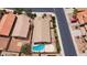 Aerial view of a private backyard with a pool, well-manicured landscaping and a patio at 42076 W Colby Dr, Maricopa, AZ 85138