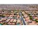 Wide aerial view of a residential area filled with many single-story homes with red tile roofs at 42076 W Colby Dr, Maricopa, AZ 85138